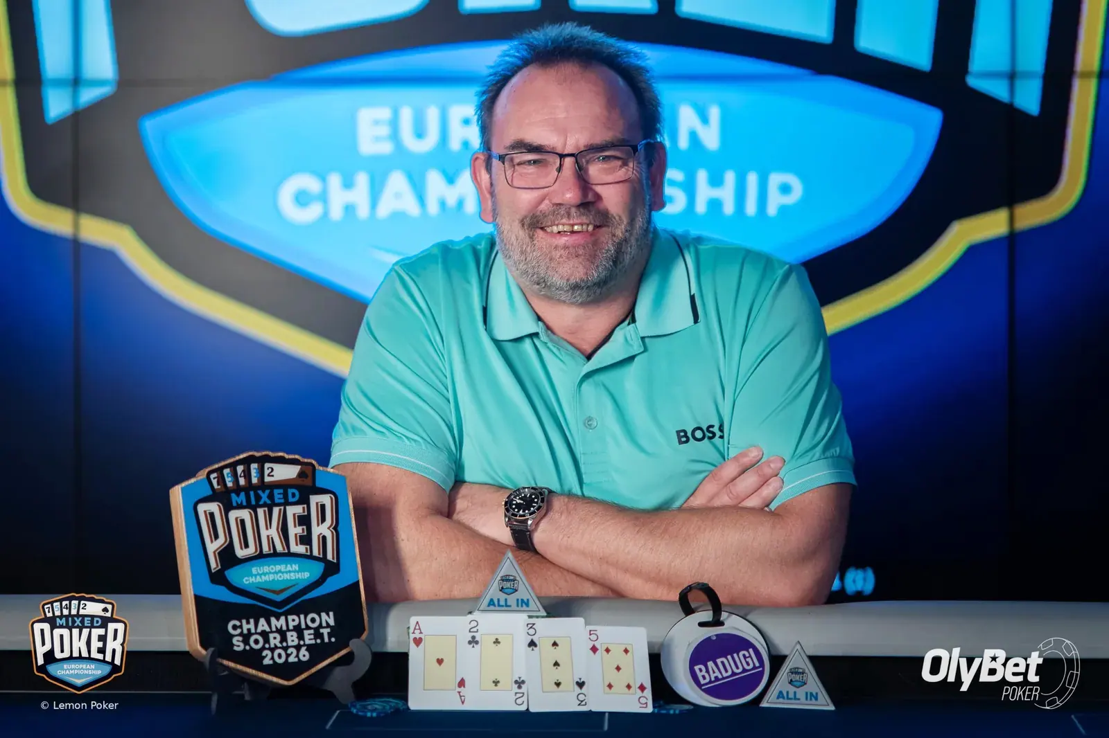 Forsland with the trophy and his final hand: A♥ 2♣ 3♠ 5♦, a five-high badugi.